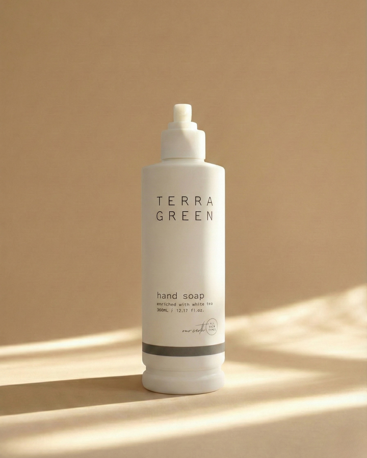 Terra Green hand soap bottle on a beige background