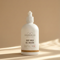 White bottle of Woodbury & Co. body wash on a beige background