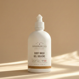 White bottle of Woodbury & Co. body wash on a beige background