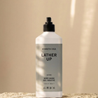 Bottle of Kenneth Cole body wash on a beige background
