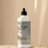 Bottle of Kenneth Cole body wash on a beige background