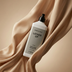 Kenny Cole Lather Up body wash bottle on beige fabric