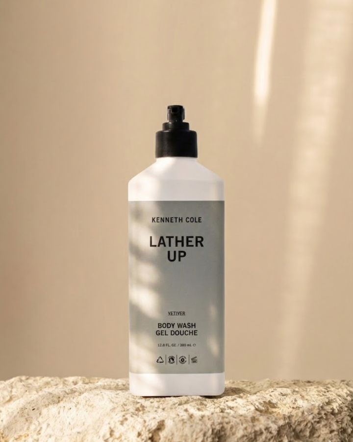 Bottle of Kenneth Cole body wash on a beige background