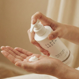 Person holding a bottle of Terra Green product with foam on palm