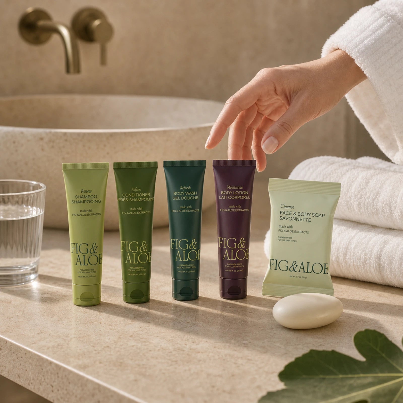 Fig and Aloe travel-size amenities prepared for a guest on a modern hotel bathroom vanity