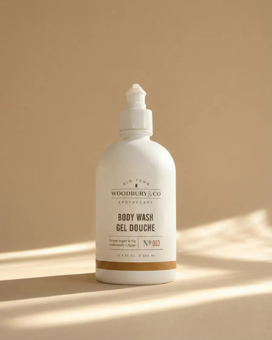 Woodbury & Co body wash bottle on a warm neutral background