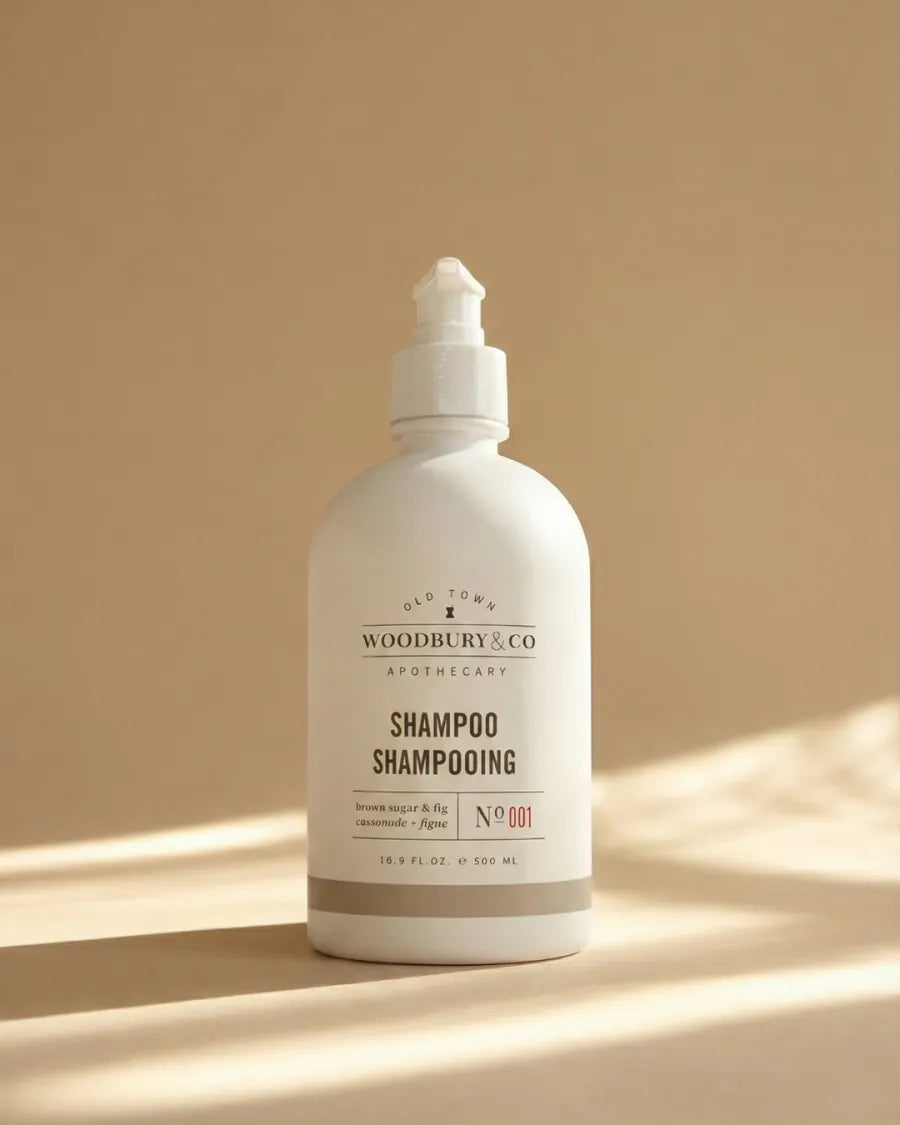 Woodbury & Co shampoo bottle on a warm neutral background
