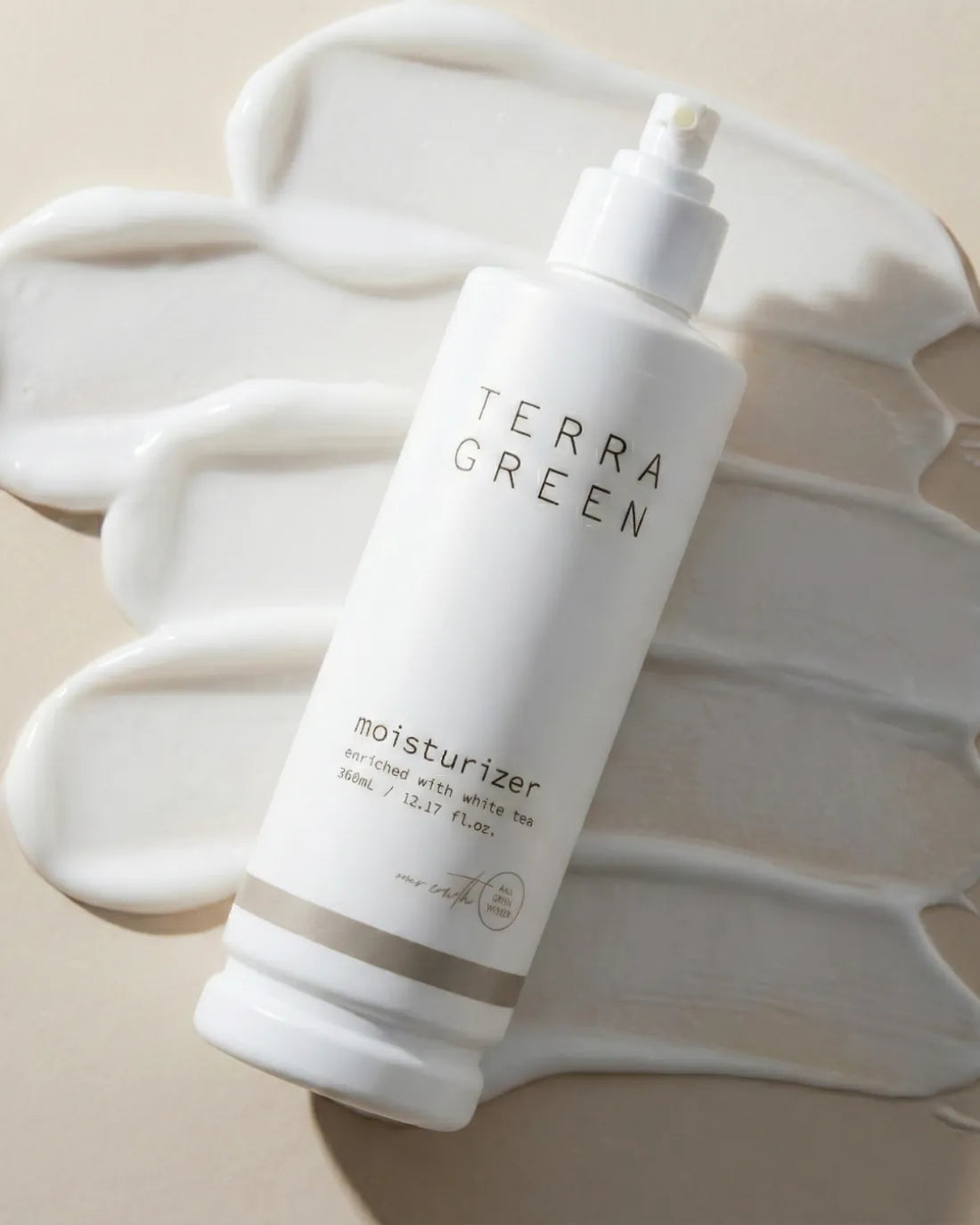 Terra Green moisturiser bottle on a soft cream background