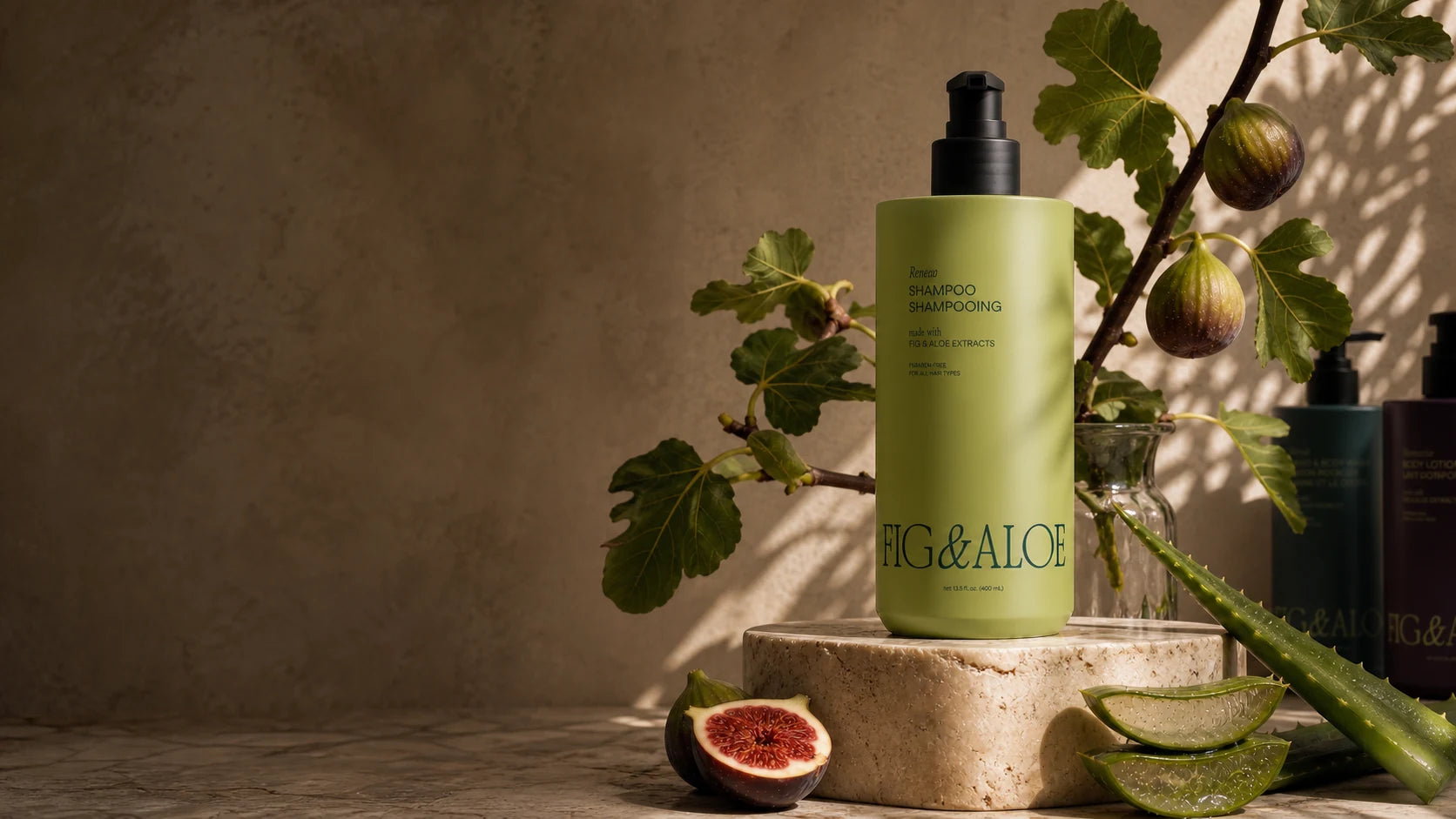 Fig and Aloe Stratus dispenser styled with fresh figs and aloe leaves